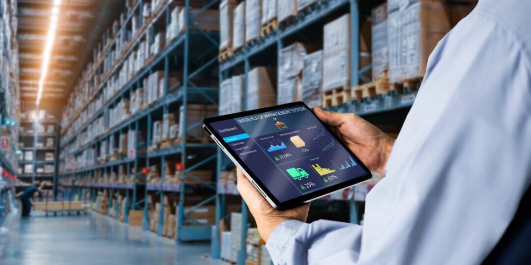 Warehouse Management with Tablet Worker using a tablet to view warehouse management system data in a large warehouse.