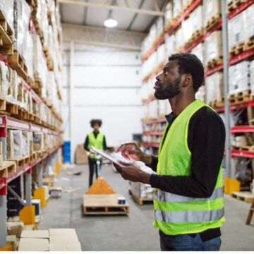 Inventory Management in Warehouse Worker using a tablet for inventory management in a warehouse.