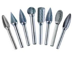 Assorted metal rotary tool bits for shaping materials.