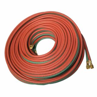 A coiled red and green welding hose with brass fittings at each end.