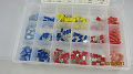 A plastic organizer containing a variety of colored wire connectors, including red, blue, and yellow.